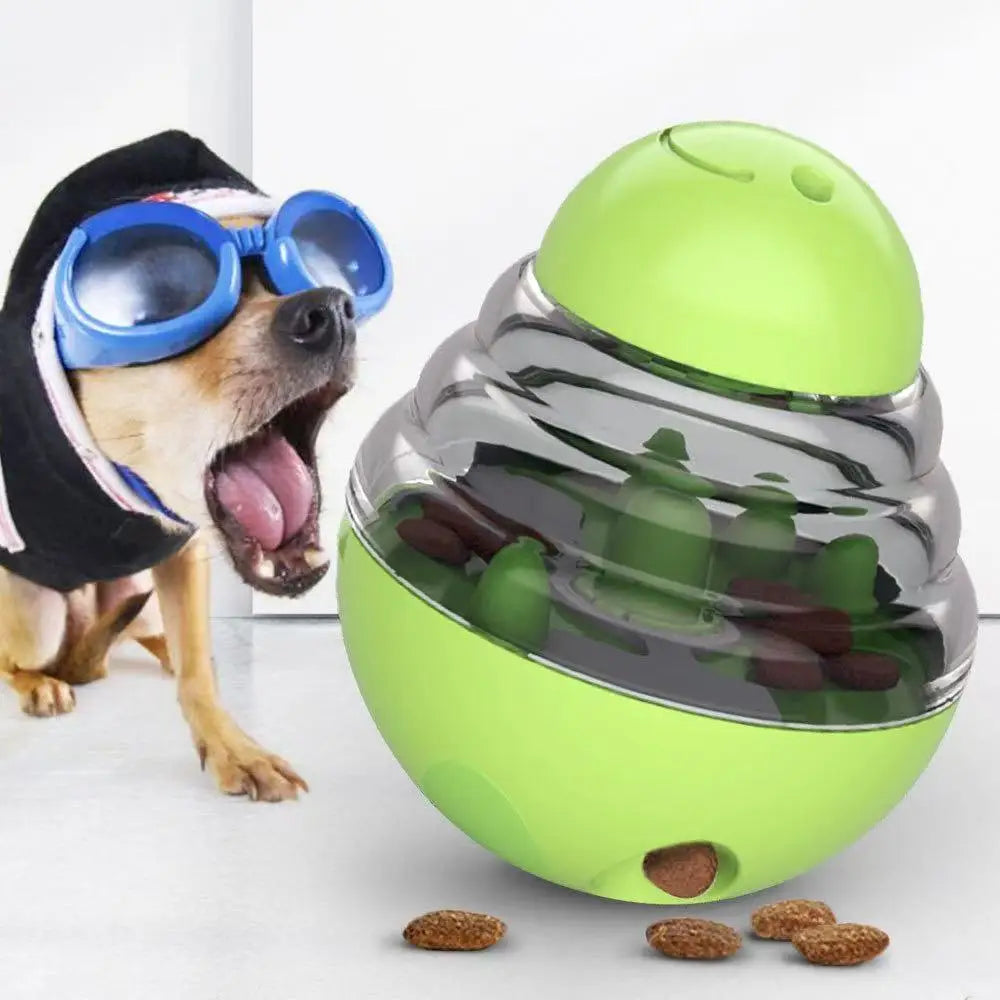 Dog wearing goggles with a green and gray toy filled with treats on a white background