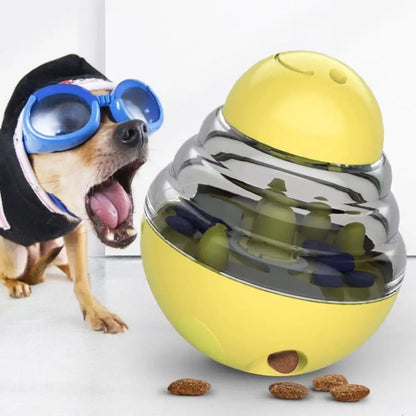 Dog wearing goggles next to a yellow and silver ball-shaped pet toy with treats inside.