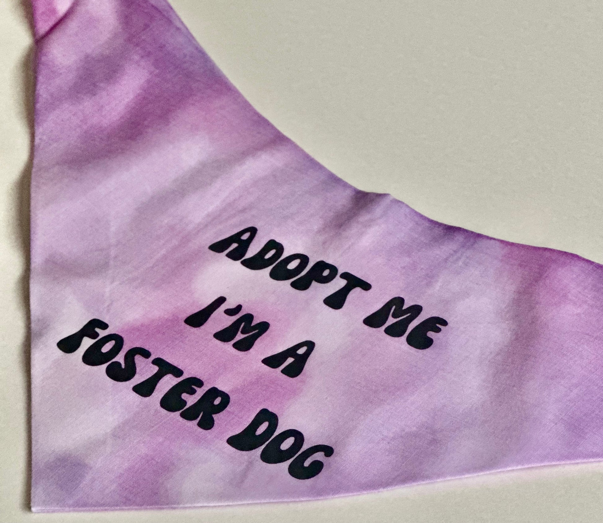 Purple bandana with 'Adopt Me I'm a Foster Dog' text on a light background