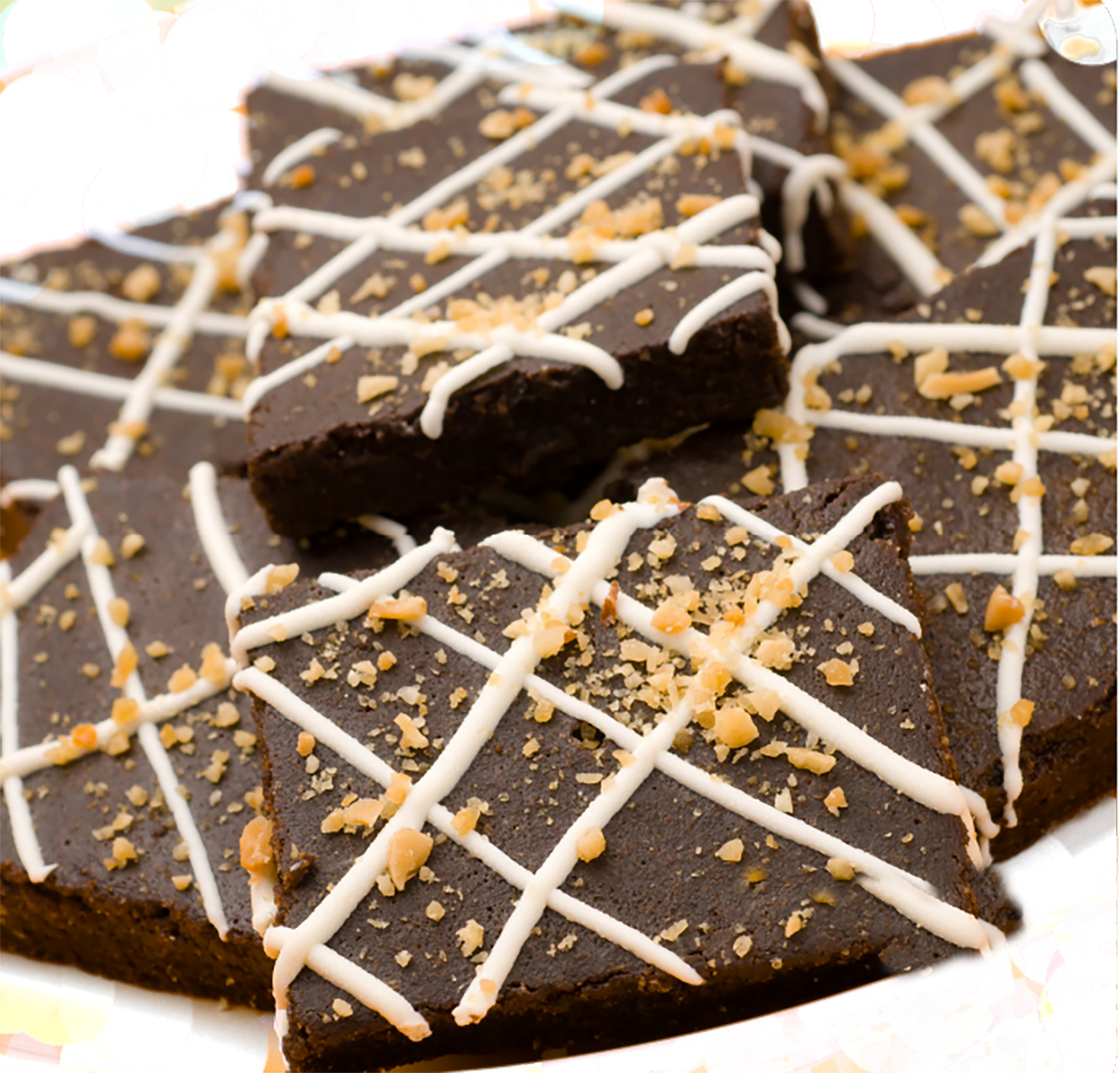 Chocolate bars with white drizzle and sprinkles on a white plate