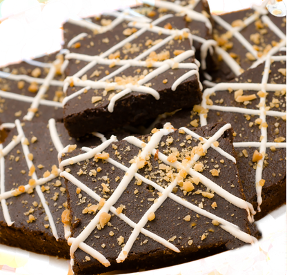 Chocolate bars with white drizzle and sprinkles on a white plate