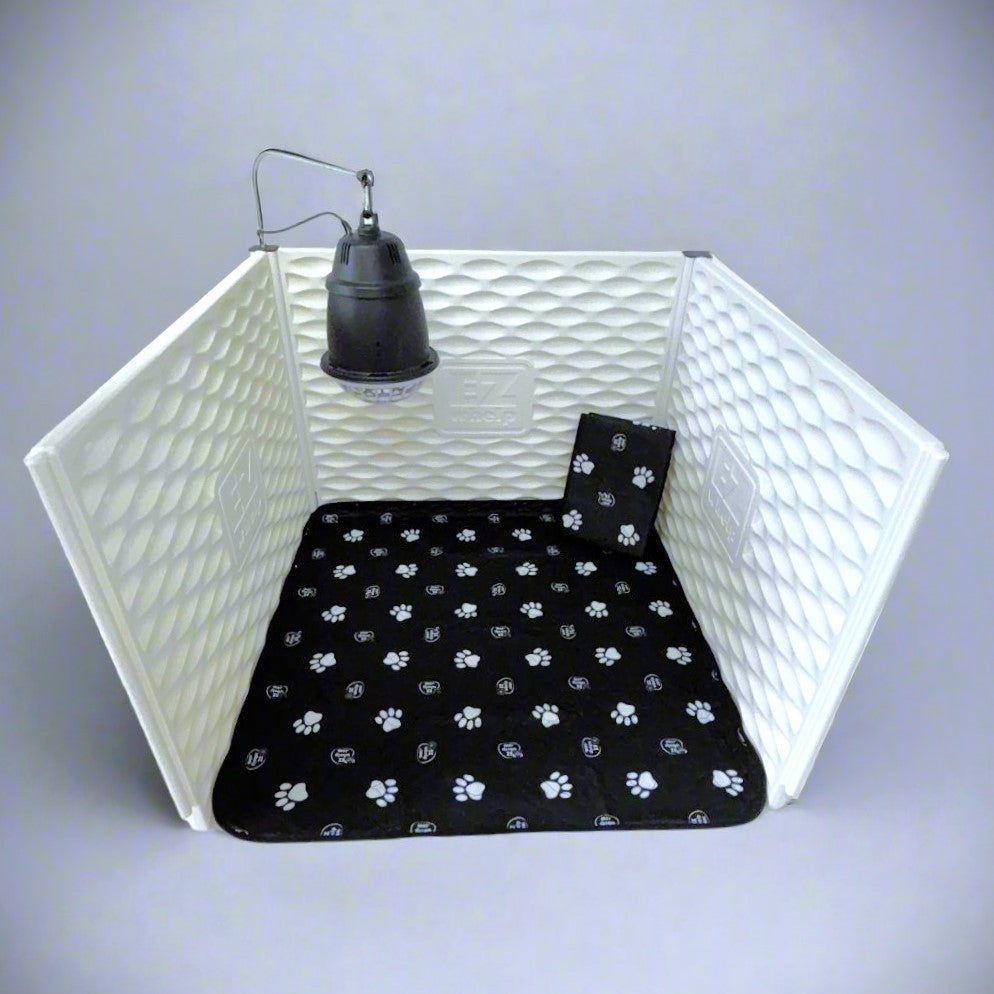 White pet playpen with a black paw-patterned mat inside on a gray background