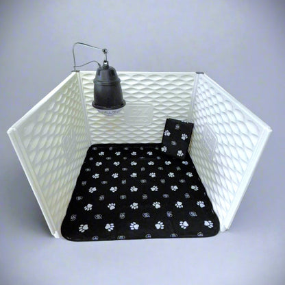 White pet playpen with a black paw-patterned mat inside on a gray background