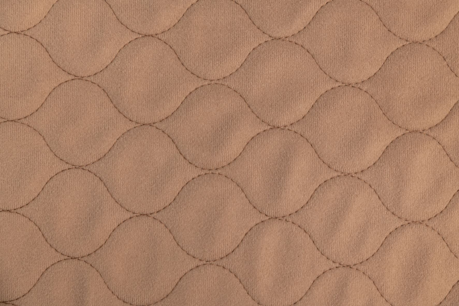 Close-up of brown quilted fabric texture