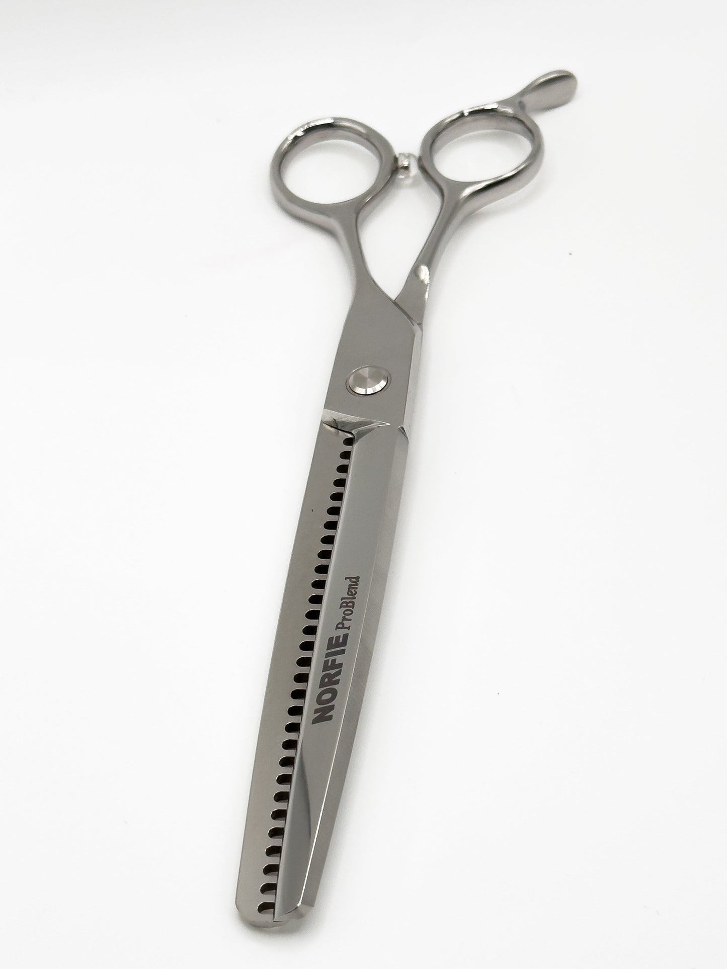 Silver hairdressing scissors with 'Noreva' branding on a white background