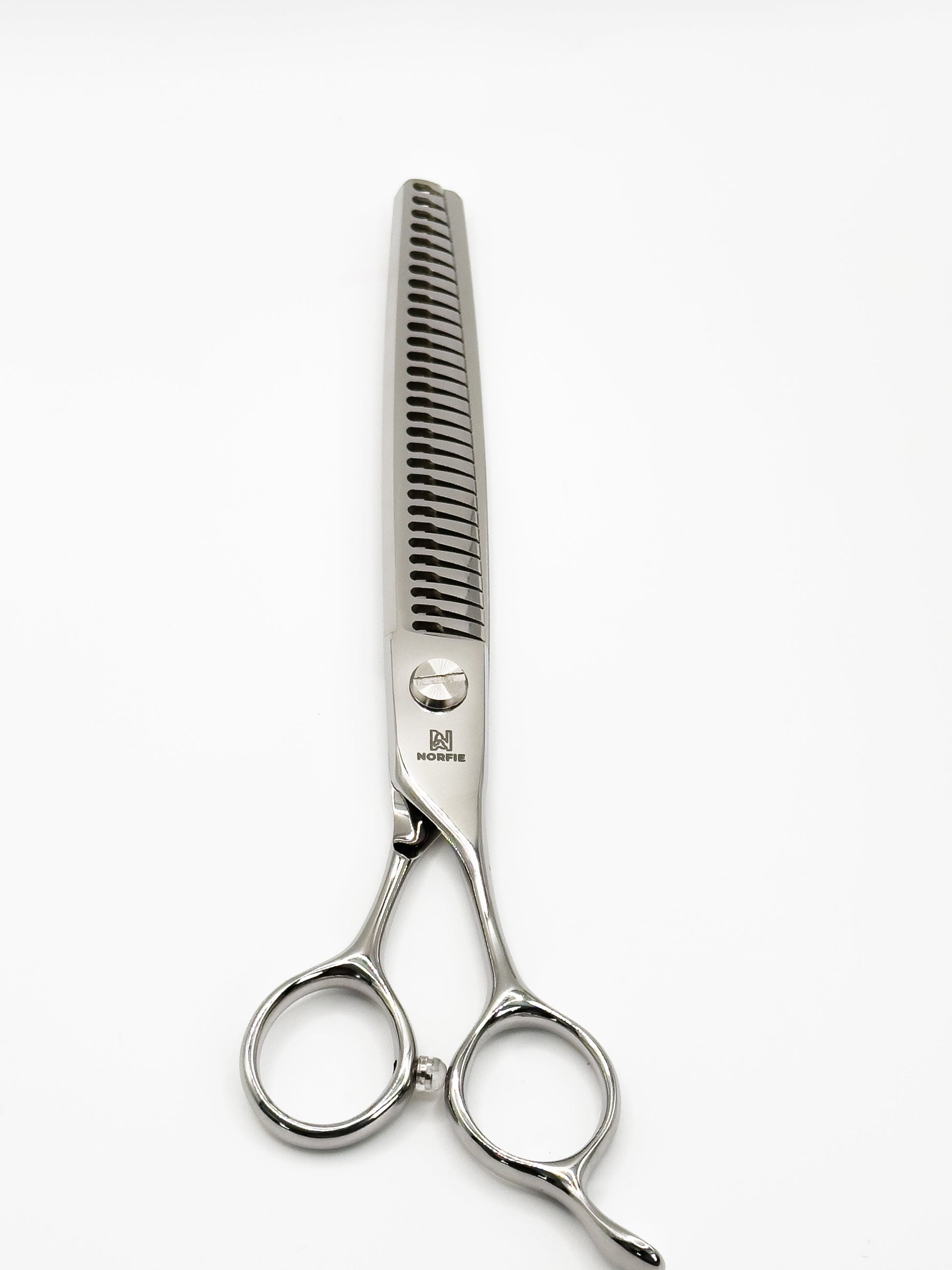 Hair cutting scissors and comb on a white background