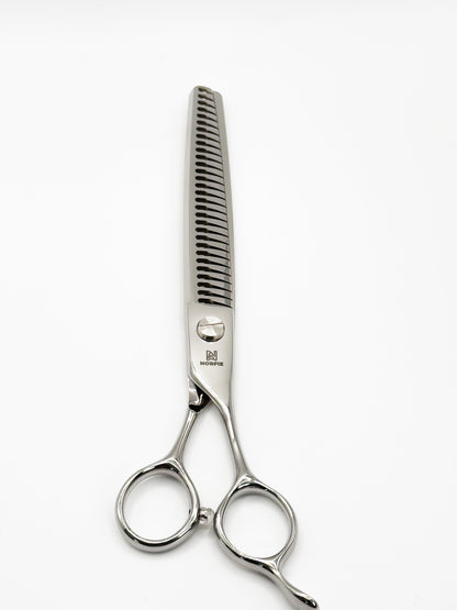 Hair cutting scissors and comb on a white background