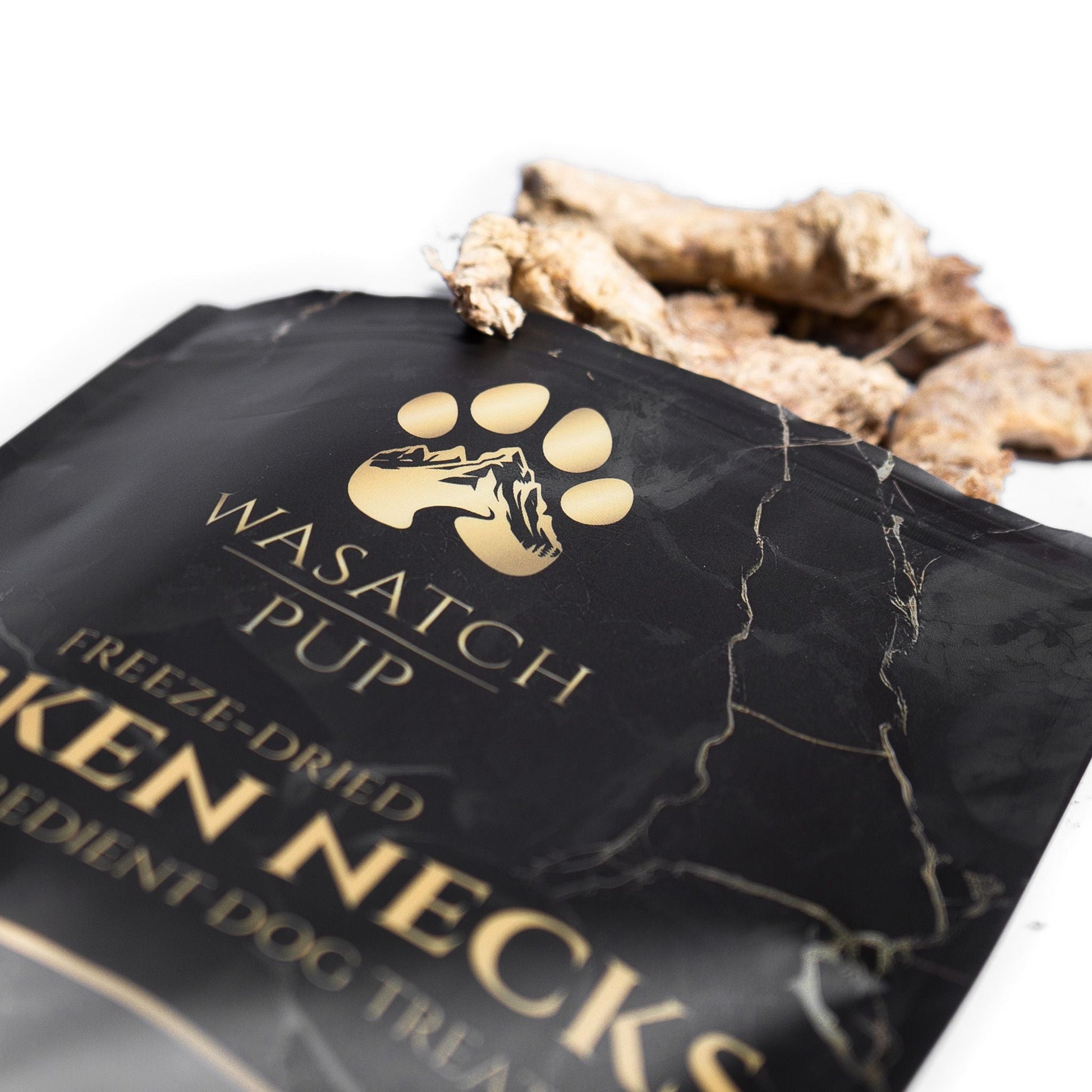 Wasatch Pup freeze-dried chicken necks packaging with chicken necks peeking out.