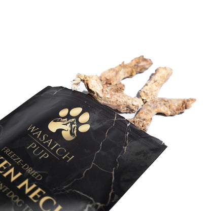 Black package of Wasatch Pup dog treats with a paw print logo on a white background