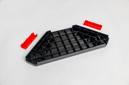 Black plastic tray with red clips on a white background