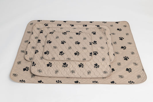 Beige pet mat with black paw prints on a white background