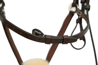Close-up of a brown leather bridle with a white background