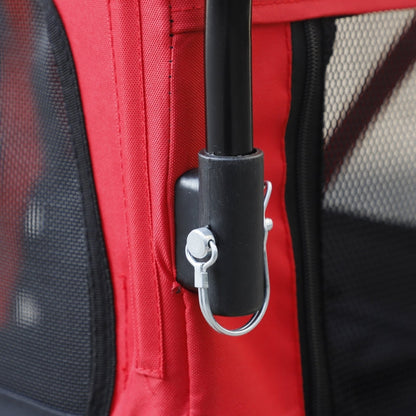 Close-up of a red bag with a black handle and metal clasp.