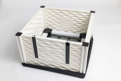 White pet crate with black straps on a white background