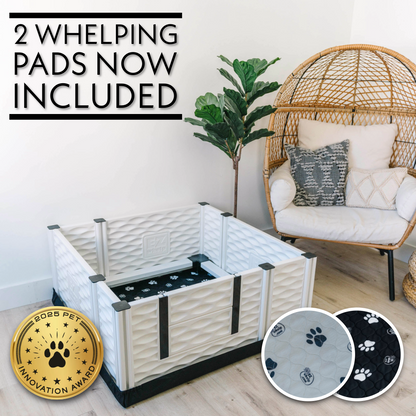 Pet playpen with whelping pads included, shown in a home setting.