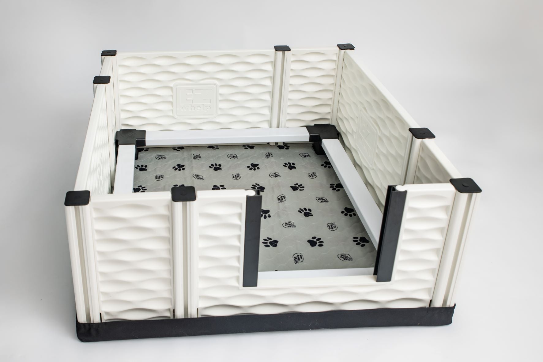Pet playpen with a paw print mat on a gray background