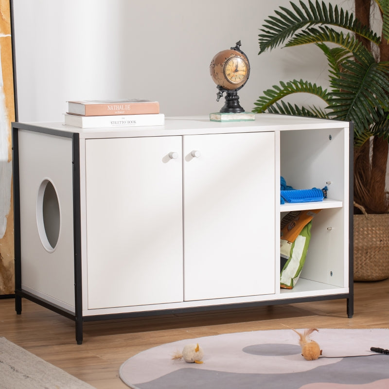 White storage cabinet with black accents in a room with a plant and books on top.
