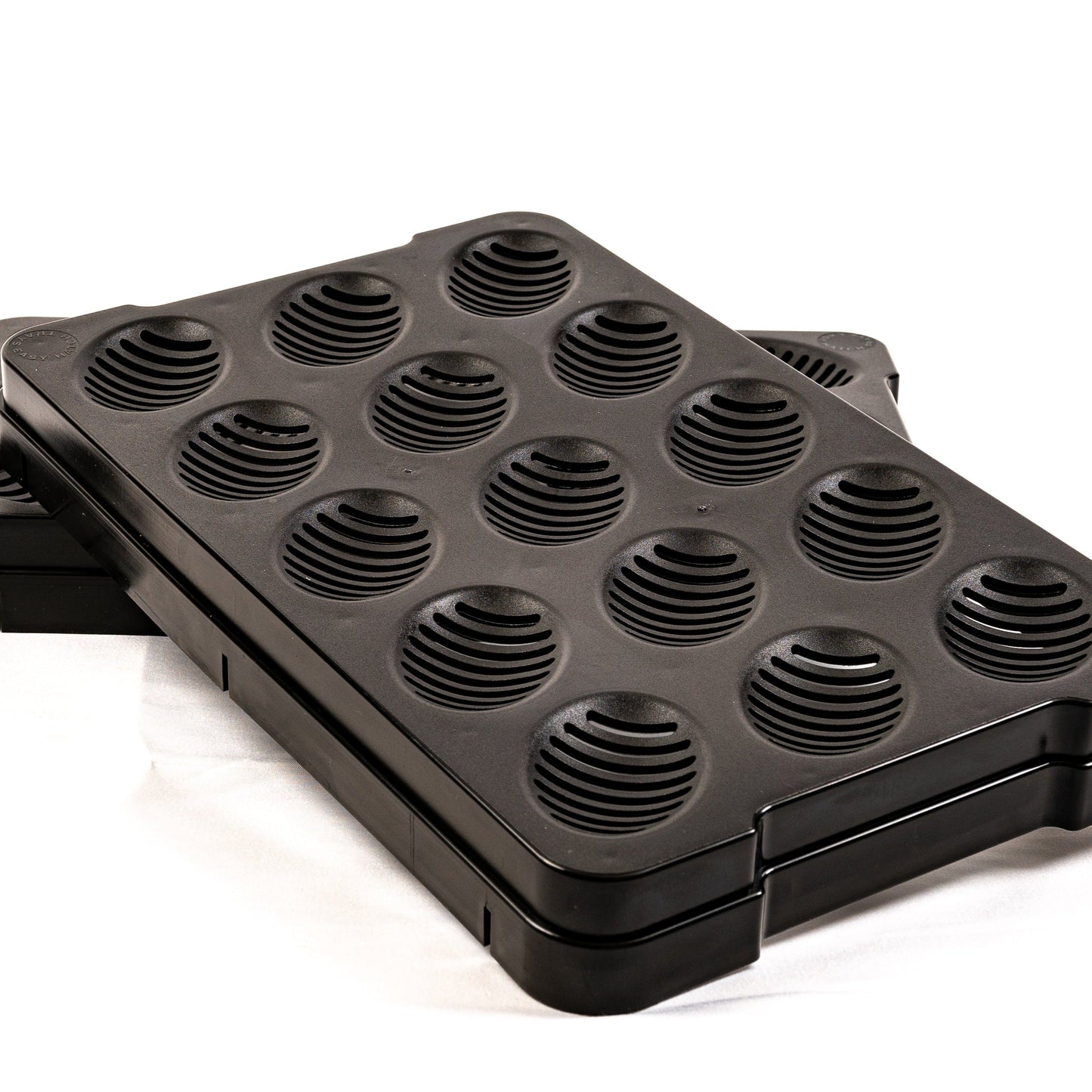 Black waffle maker with multiple round cooking sections on a white background
