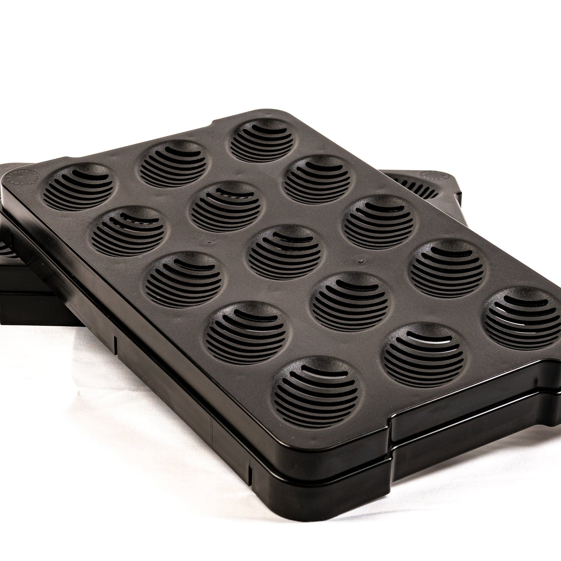 Black waffle maker with multiple round cooking sections on a white background