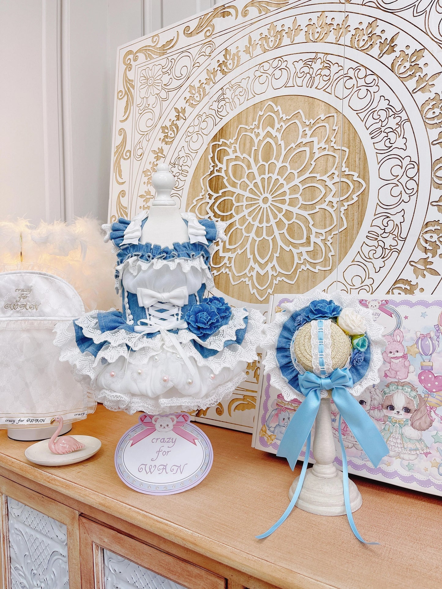 Decorative items including a blue and white cake, flowers, and a decorative box on a wooden surface.