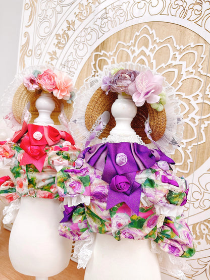 Decorative dolls with floral and ruffled outfits on a decorative stand.