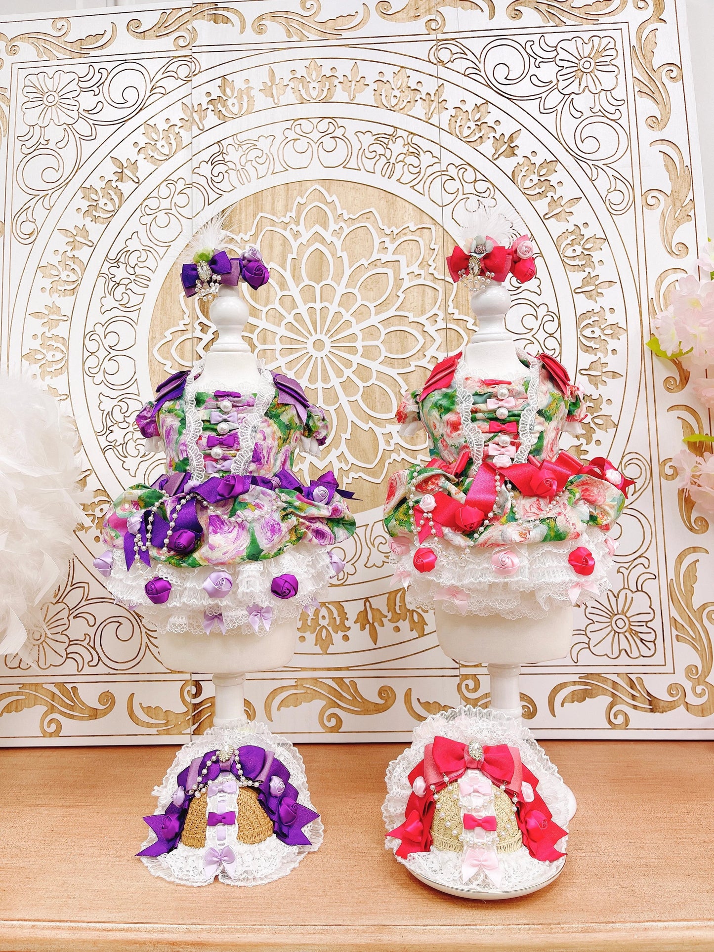 Decorative items with flowers on a wooden surface and ornate background