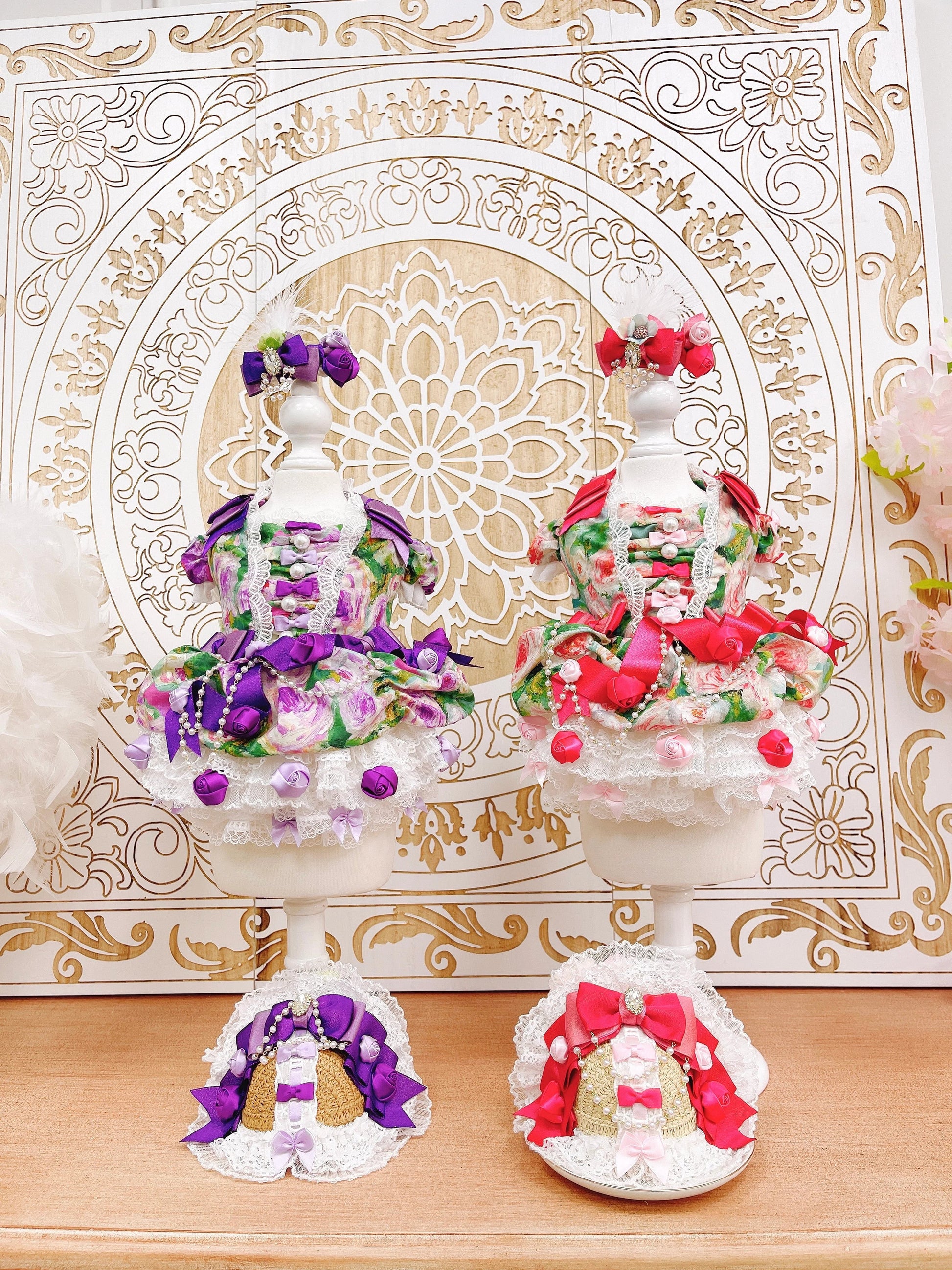 Decorative items with flowers on a wooden surface and ornate background