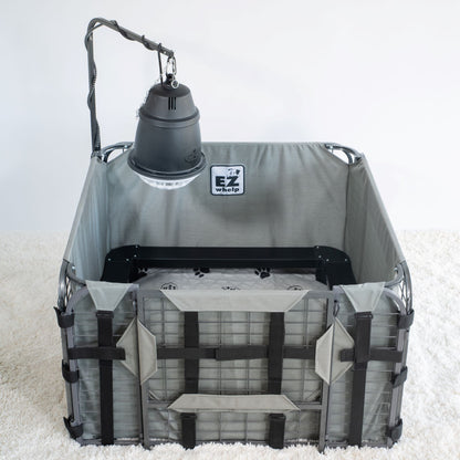 Gray pet playpen with a hanging lamp on a white background