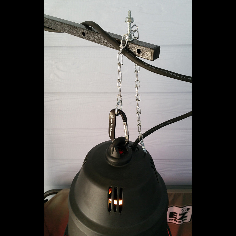Black metal bell with chain and carabiner on a white background
