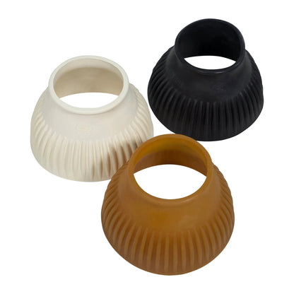 Three ribbed silicone cups in black, white, and brown on a white background