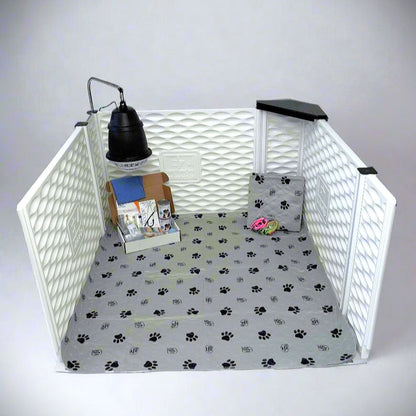 Pet playpen with a lamp, books, and a toy on a white background