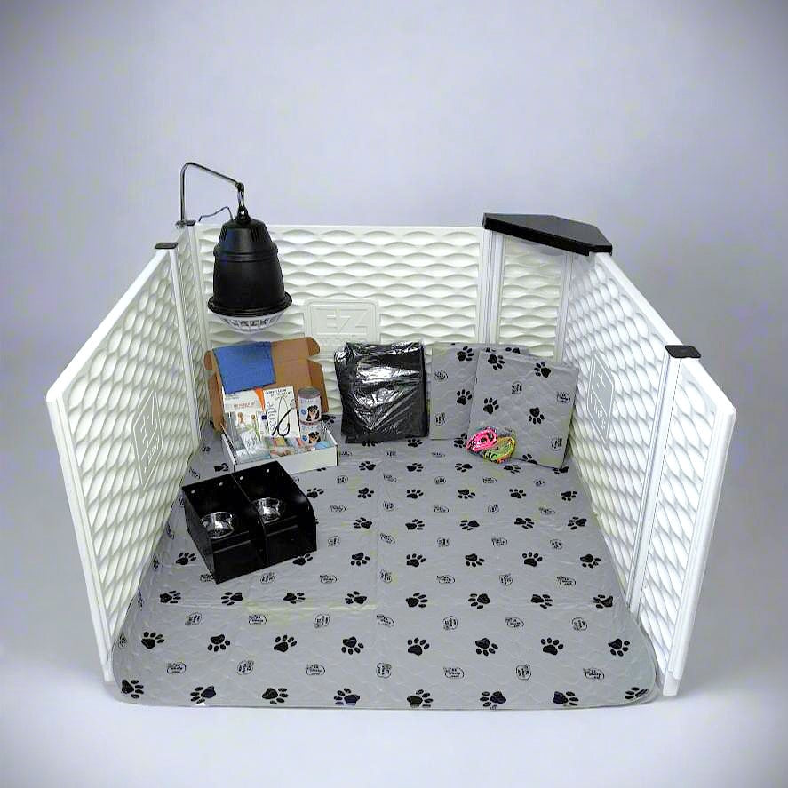 Pet playpen with paw print bedding, toys, and a lamp on a white background