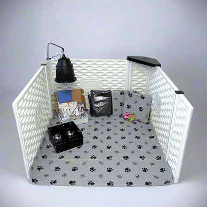 Pet playpen with paw print bedding, toys, and a lamp on a white background