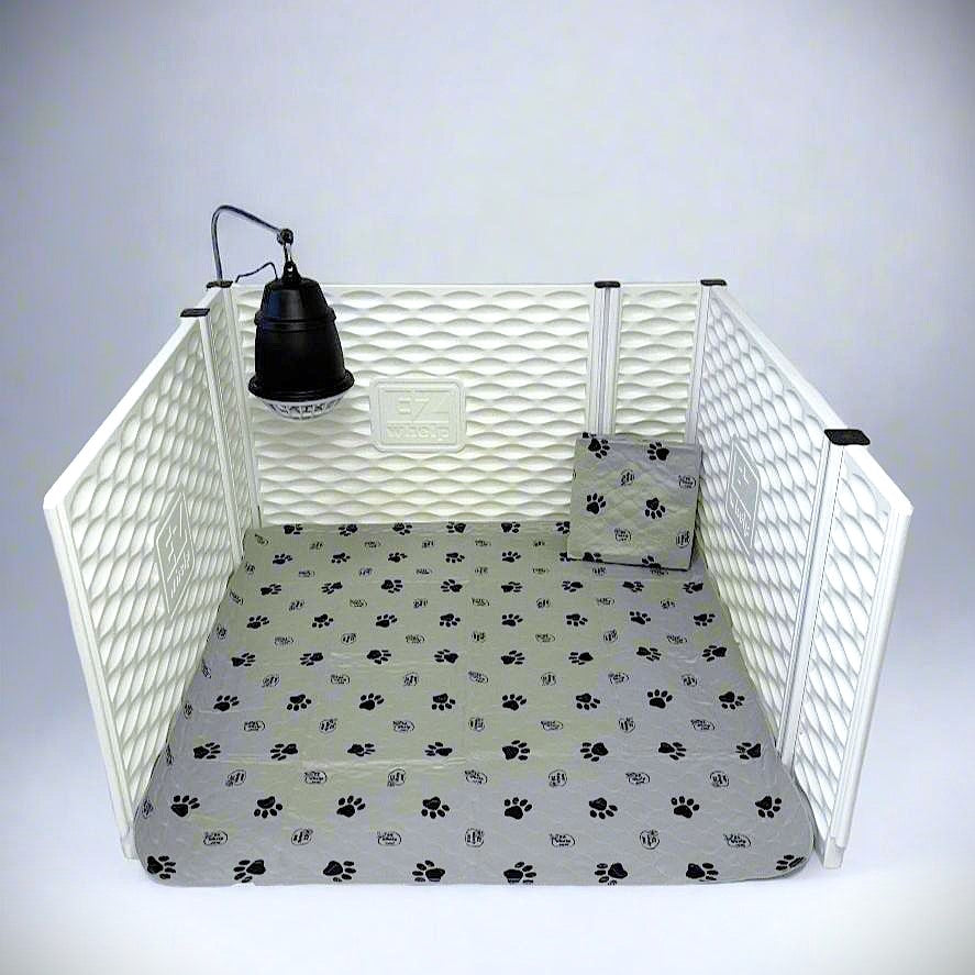 White pet playpen with a lamp and paw print mat on a gray background