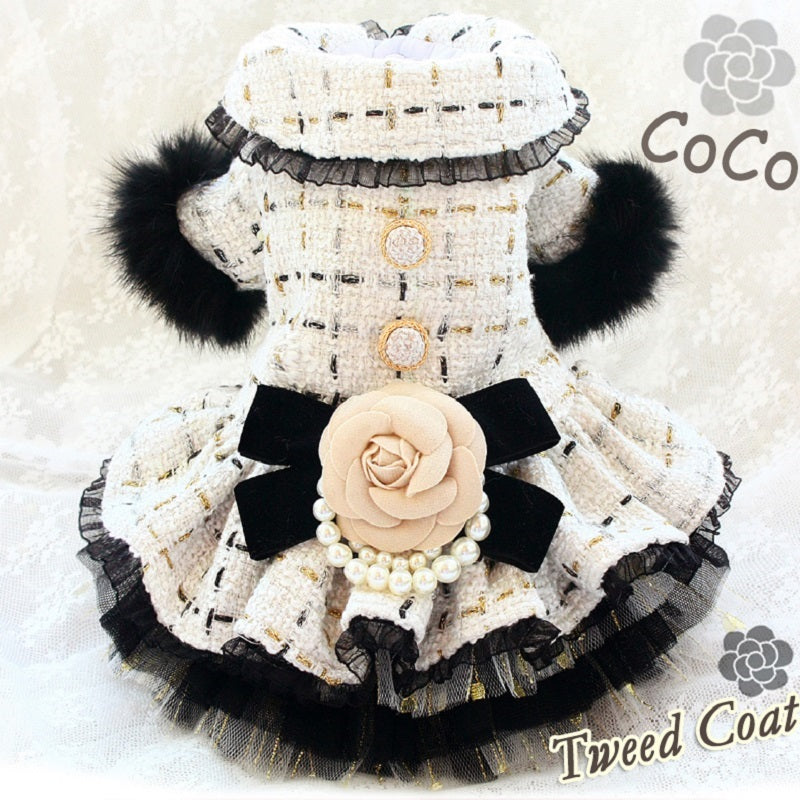 Dog coat with black and white design, featuring a rose and pearls, on a light background.