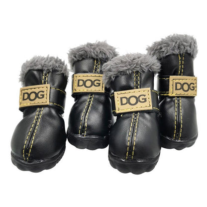 Four black dog boots with gray fur lining and gold accents on a white background