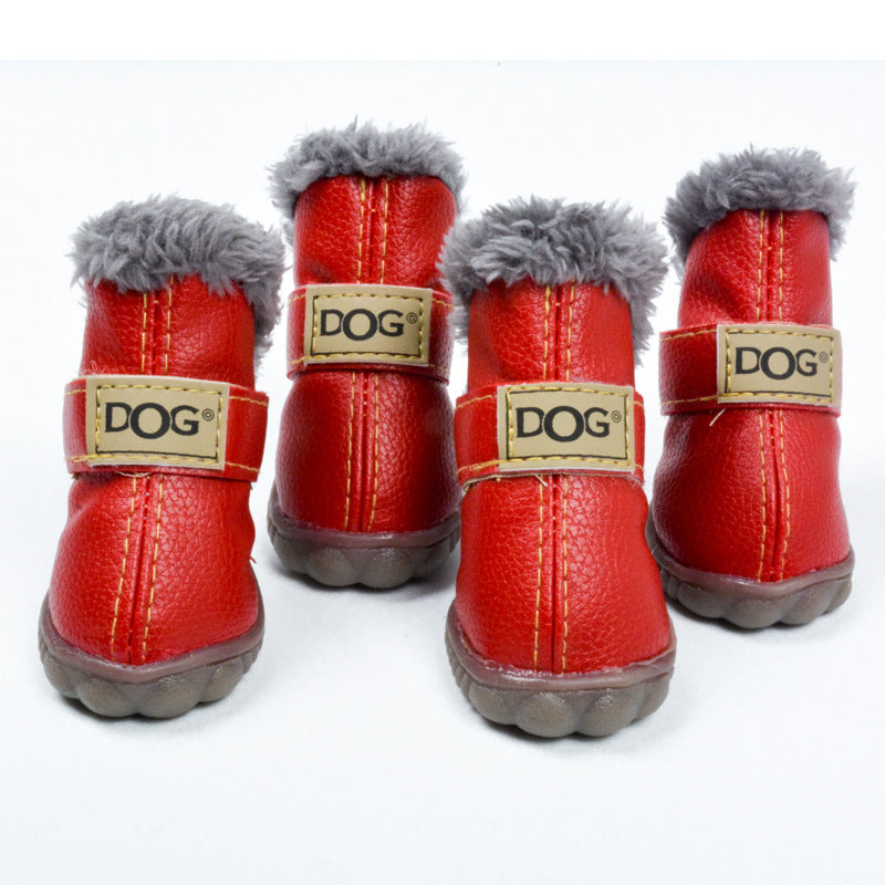 Four red dog boots with gray fur on a white background