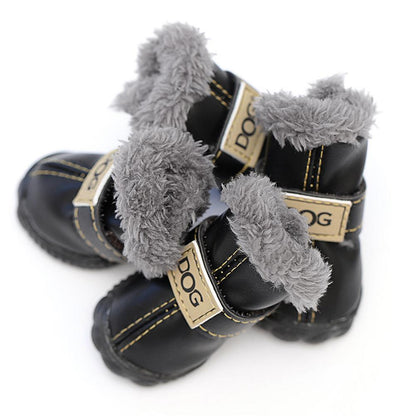 Pair of black dog boots with gray fur trim on a white background