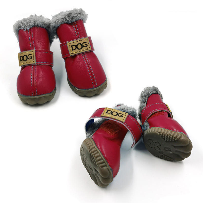 Red dog boots with gray fur lining and 'DOG' label on a white background