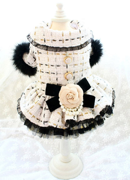 Black and white dress on a mannequin with decorative elements against a white background