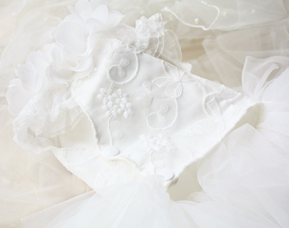 Close-up of a white wedding dress with intricate details