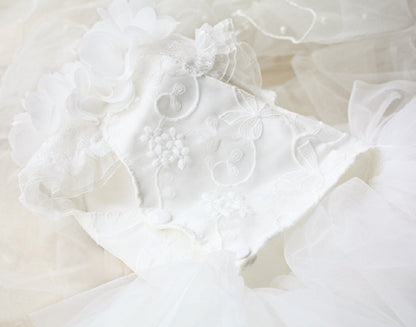 Close-up of a white wedding dress with intricate details