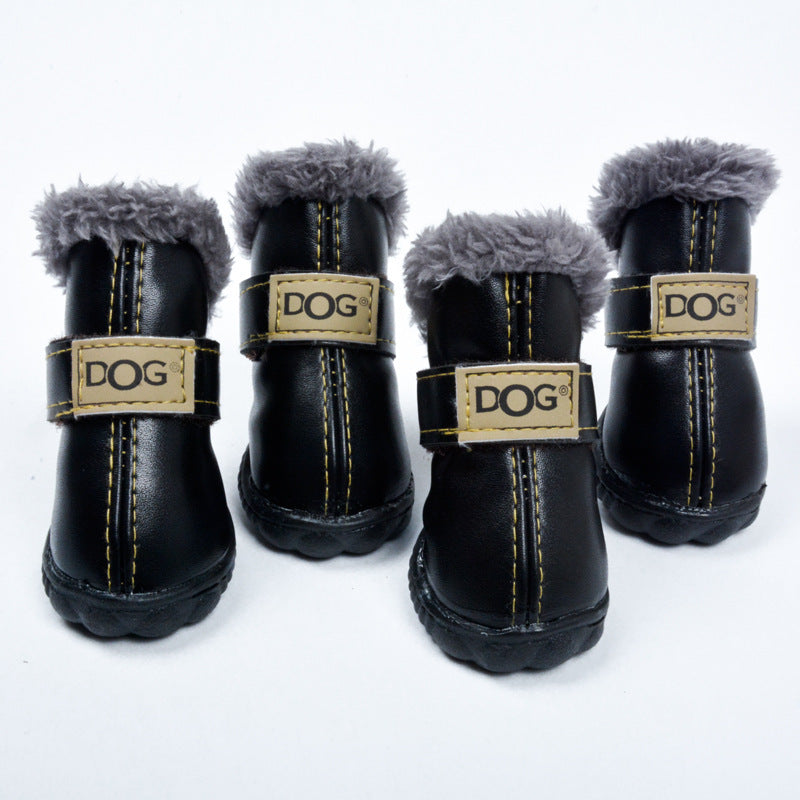 Four black dog boots with gray fur lining and gold 'DOG' labels on a white background.