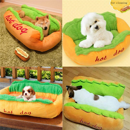 Hot dog-shaped pet bed with dogs inside on a wooden floor.