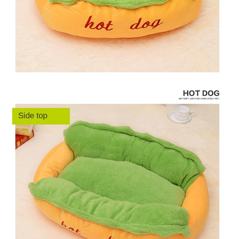 Hot dog-shaped pet bed with green blanket on a beige surface