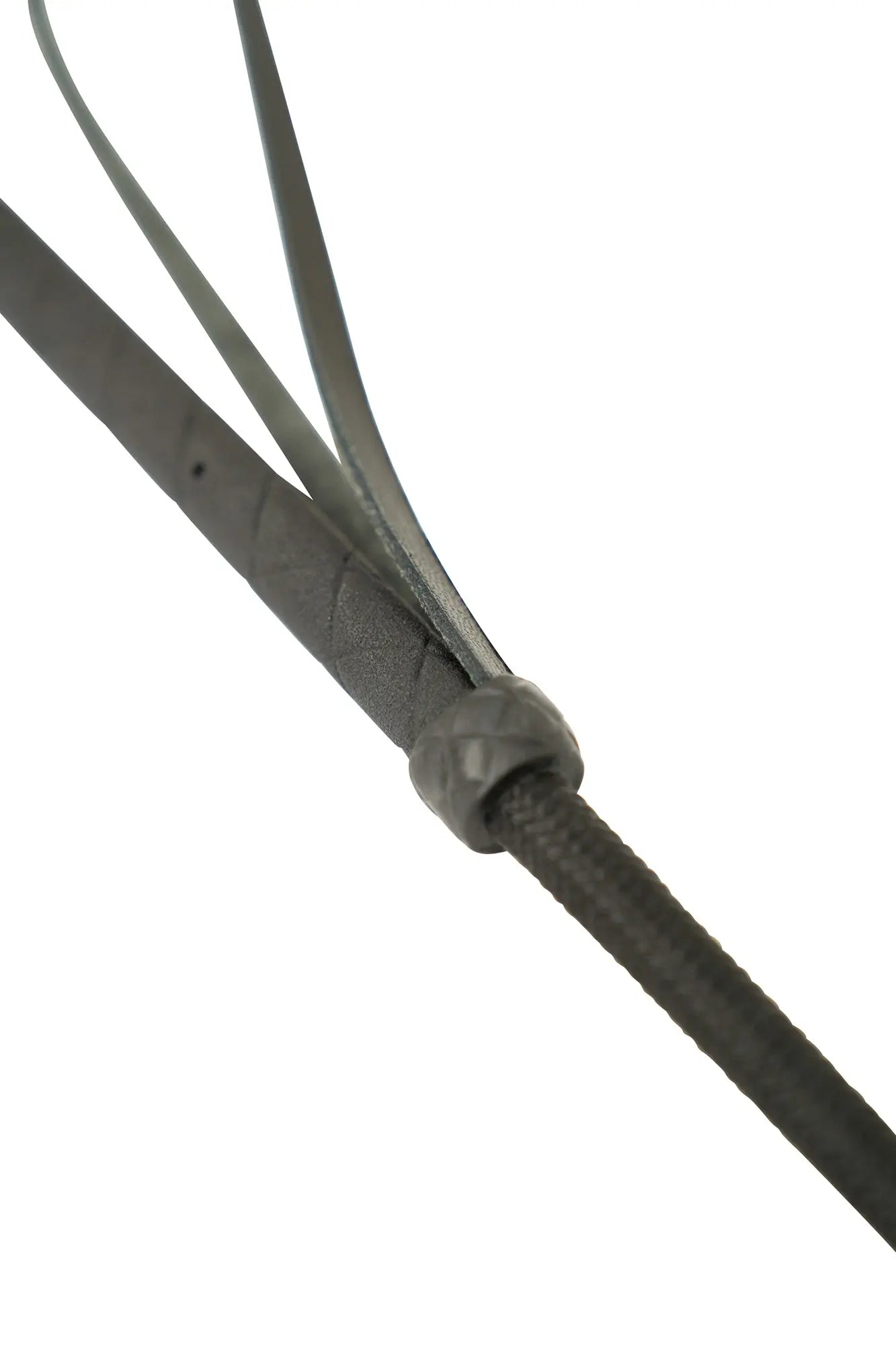 Close-up of a black leather strap with a metal buckle on a white background