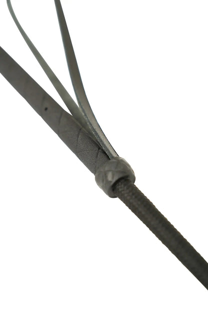 Close-up of a black leather strap with a metal buckle on a white background