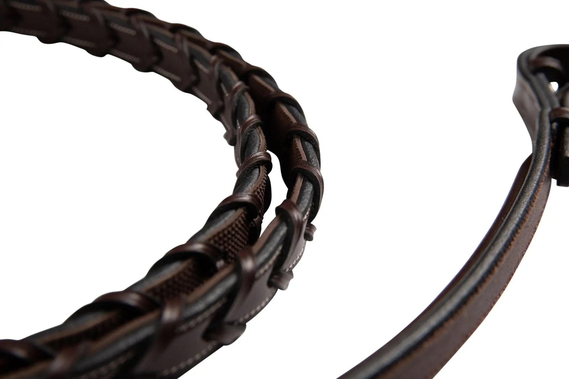 Close-up of a brown leather bridle on a white background