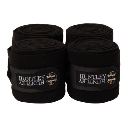 Four rolls of black Huntley bandage on a white background