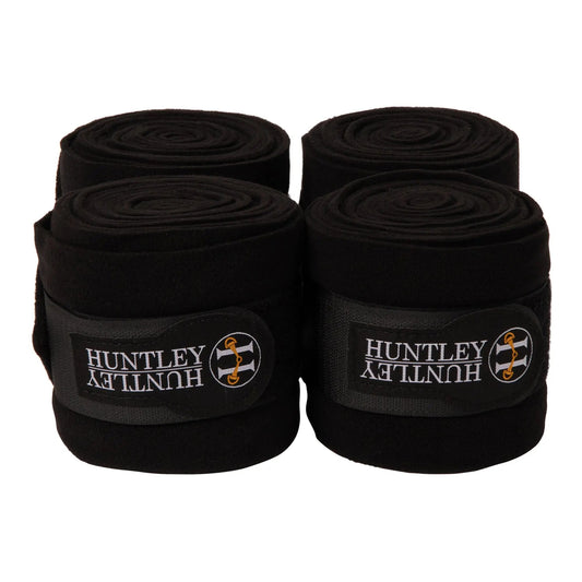 Four rolls of black Huntley bandage on a white background